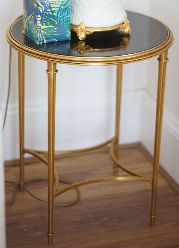 A pair of gilt metal and black lacquer circular side tables, 50cm diameter x 60cm high.