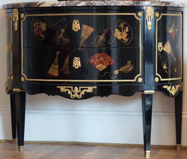 A Louis XVI style ormolu mounted, chinoiserie decorated, black lacquer commode, 110cm wide x 85cm high.