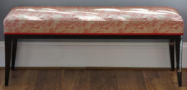 A lacquered rectangular stool on swept legs, 120cm wide x 50cm high.