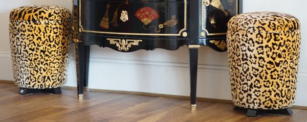 A pair of leopard print upholstered stools, of circular tapering form, 40cm diameter x 53cm high.