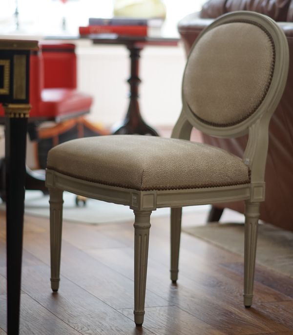 A pair of Louis XVI style grey painted oval back silver upholstered side chairs, 55cm wide x 88cm high, (2)..