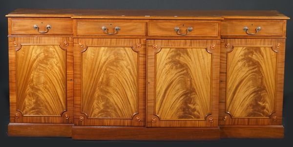 Martin J Dodge; a George III style mahogany breakfront bookcase, with four drawers over moulded panelled doors, on a plinth base, 198cm wide x 98cm hi