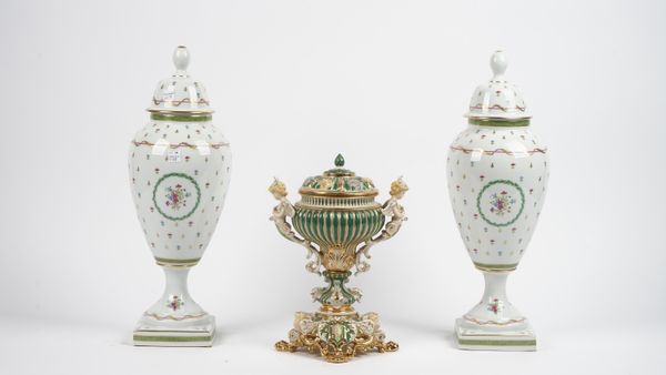 A Thomas Goode porcelain vase and cover, modern, with twin cupid handles and a shell moulded cover, gilt/green on a pierced base and lion paw feet, 30