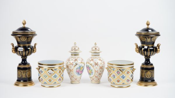 A pair of modern porcelain and gilt metal mounted vases and covers, each of twin handled urn form, gilt decorated against a cobalt blue ground, 42cm h