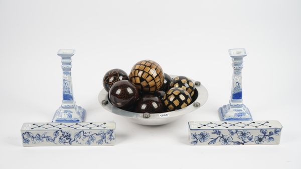 A modern pewter bowl, 42cm diameter, containing a selection of lacquered composite carpet bowls, two Chinese style porcelain pillows with blue and whi