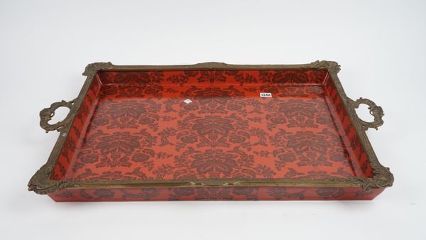 A pair of modern porcelain and gilt metal mounted, twin handled trays, each foliate decorated against a red ground, blue printed marks, 82cm wide, (2)