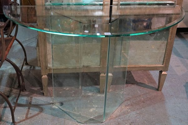 A modern demi-lune glass console table, on a glass base, 120cm wide x 75cm high.