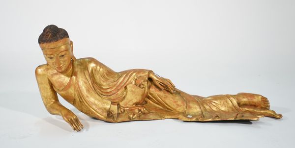 A modern bronze figure of a reclining Buddha, 113cm wide x 49cm high.