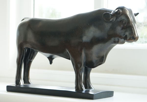 A modern faux bronze model of a bull, 32cm long.