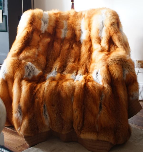 A light brown, tan and white fur throw, 195cm x 206cm.