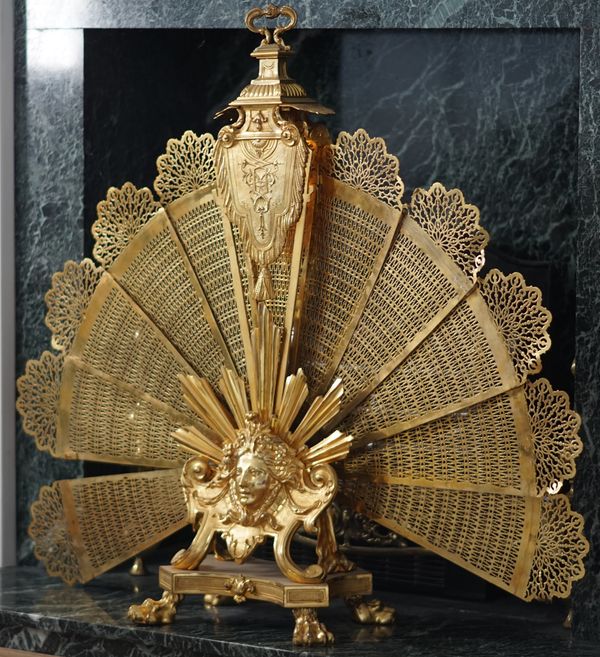 A French gilt metal pierced fan fire screen, 88cm high.