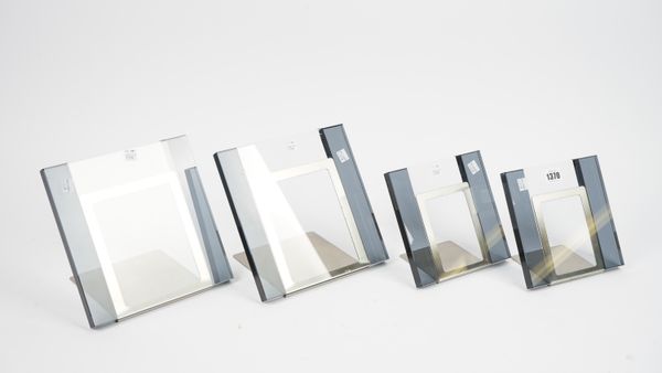 A set of four coloured glass and brushed steel photograph frames, each of contemporary square form of two differing sizes, the largest 22.5cm high, (4