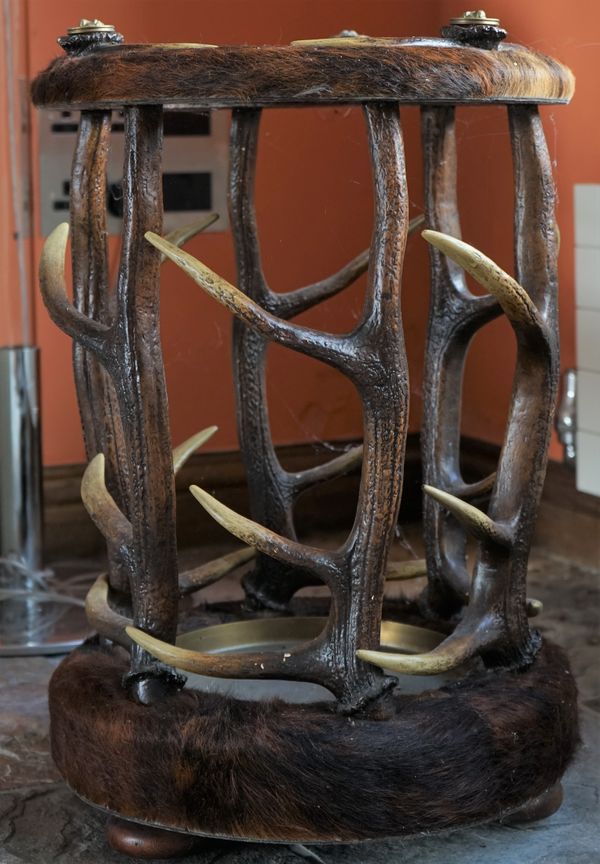 A hide and horn circular stick stand, 43cm diamter x 62cm high.