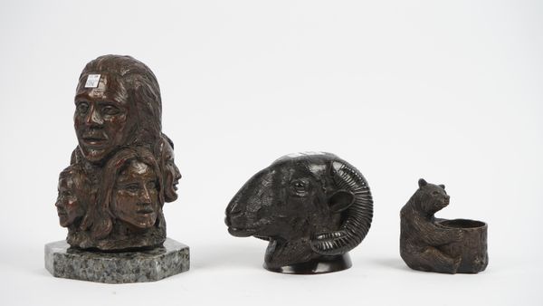 A modern patinated bronze rams head, 14cm high, a patinated bronze bear modelled holding a bear, 11cm high, and a modern bronze family bust group on a