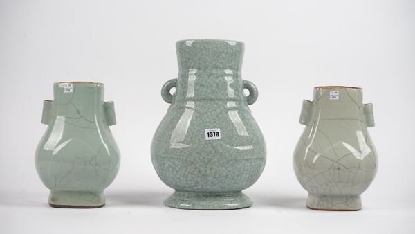 A modern Chinese style celadon vase with twin loop handles and all over crazing, 35cm high, and a smaller pair of Chinese style celadon pottery vases,