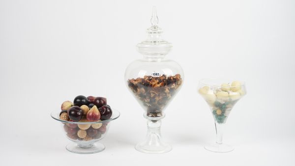 A William Yeoward glass footed bowl containing faux fruit, 32cm diameter, a large glass vase and cover of cylindrical tapering form raised on a spread