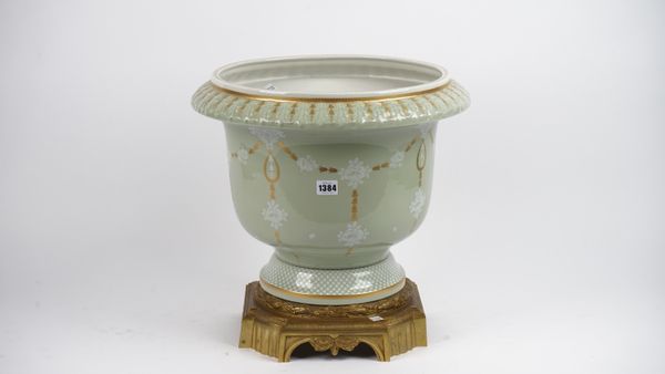 Mangani Italy; a large modern porcelain and brass mounted jardinière, gilt and white foliate decoration against a celadon green ground on a brass cant