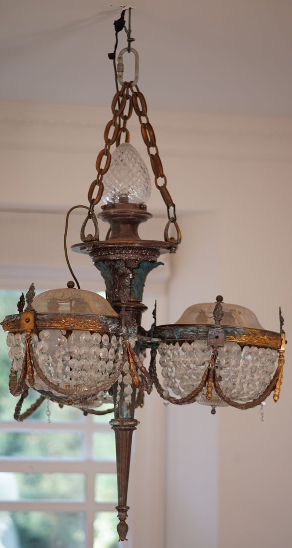 A French gilt metal and cut glass chandelier, modelled as a torch flanked by three baskets, 100cm high.