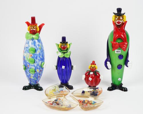 A 'Family' of four Murano coloured glass clowns and four shaped glass bowls containing a selection of Murano coloured glass sweets, (qty).