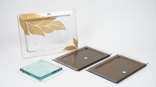 An Italian 'Griffe' glass serving tray of rectangular form with gilt lead decoration, 41cm wide, and three further glass trays, (4).