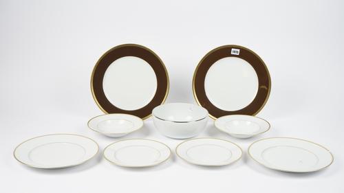 A set of twelve Haviland 'Laque de Chine' chocolate dinner plates, 31cm diameter, and a Limoges 'Raynaud' part dinner service, (qty).