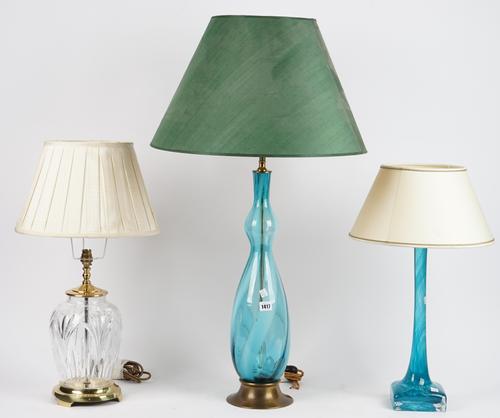 A modern blue glass table lamp of double guard form on a gilt metal base, 58cm high, a Murano style blue glass table lamp and a clear crystal table la