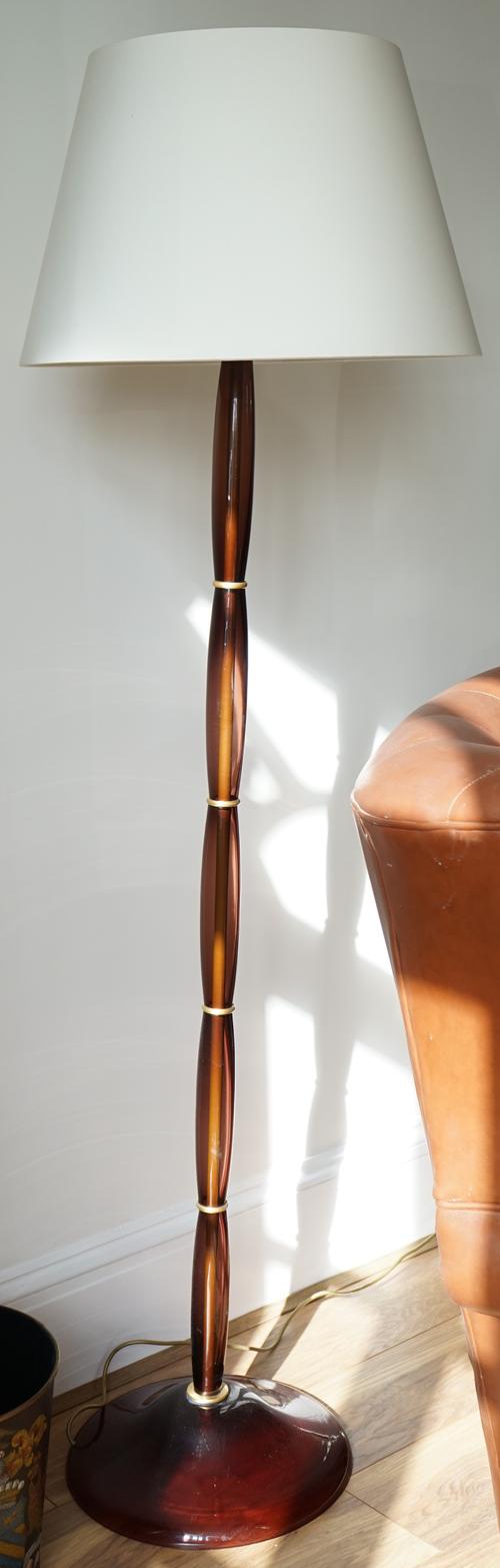 A pair of gilt metal and coloured glass baluster stem sectional standard lamps, 176cm high, only one shade.