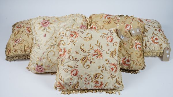 Five cream silk cushions, all with floral embroidery, (5).