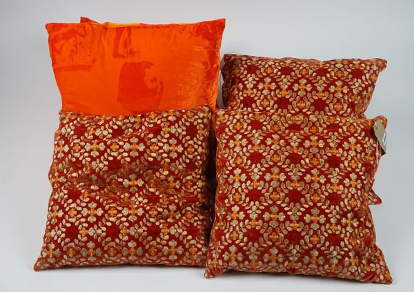 Four matching burnt orange velvet cushions with silk embroidered leaf decoration and two vibrant orange velvet cushions, (6).