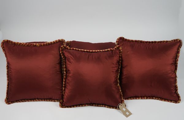 Nine maroon silk cushions, with gold and maroon tassels, (9).