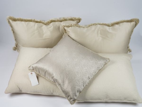 A pair of cream silk cushions, another pair of gold silk tasselled cushions and two smaller single gold silk cushions with tassels, (6).