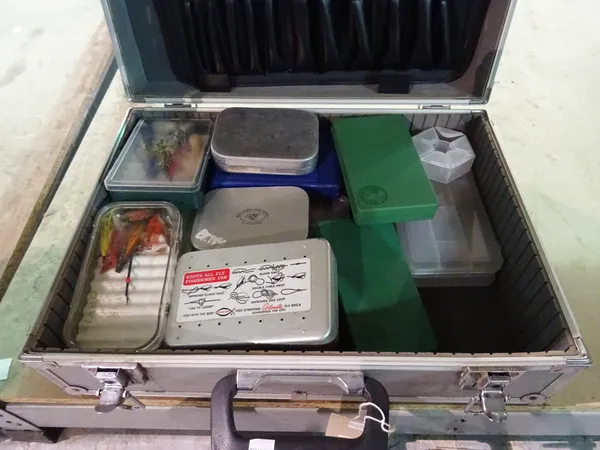 A quantity of fishing flies contained in numerous alloy and plastic boxes and related fly making equipment, (qty).