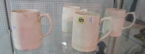 Four Wedgwood Keith Murray mugs, cream colour with banded base; five late 19th century Wedgwood majolica plates with pierced rims (23cm diameter) and