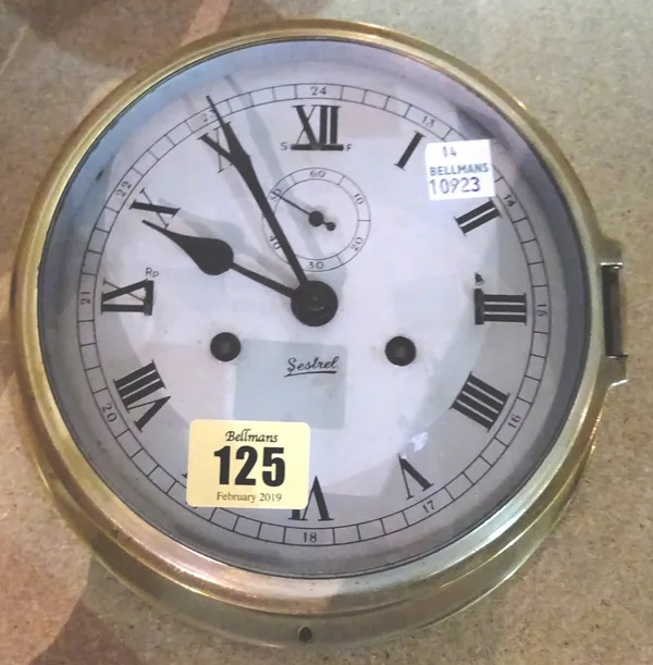 A Sestrel brass cased capstan wall clock with two train movement, subsidiary seconds dial and slow/ fast adjustments (dial diameter 15cm).