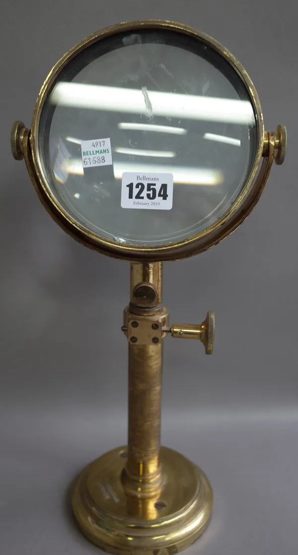 A brass bullseye lens by H.W. Sullivan, London, with adjustable 5 inch lens on a circular loaded base, 35cm high.