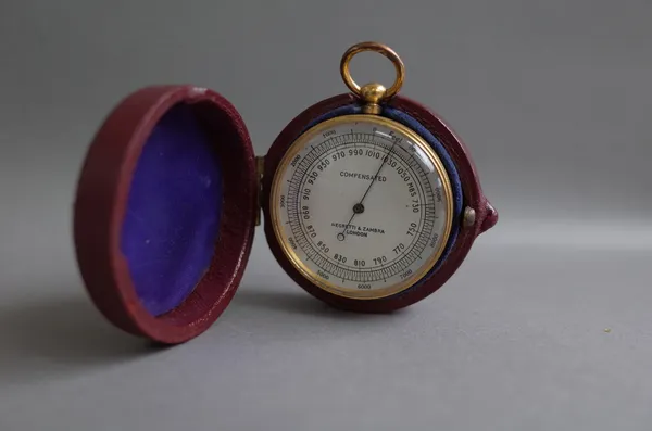 A brass cased compensated pocket barometer by Negretti and Zambra with leather case.