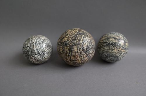 Three early 20th century ivory terrestrial pocket globes, the largest 6cm dia, (3).
