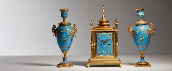 A French mantel clock garniture, C.1880, enamel on copper with jeweled and gilt decoration, with two train movement stamped Leroy et Fils Paris and ha