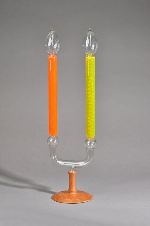 A twin branch Geissler tube mounted on a later turned wooden base, 56cm high overall. Illustrated