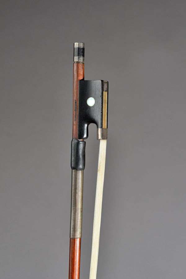 A German Violin bow with silver mounts, stamped Fritz Gutter', 71.2cm, 59.7 grams.   Illustrated