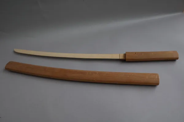 A Turkish sword Yataghan with engraved carved steel blade, 60cm, and two piece horn handle in a leather scabbard and a wooden katana sword, (2).