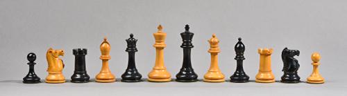 'The Staunton Chessmen', a boxwood and ebony chess set in original velvet lined mahogany box, king 10cm high.  Illustrated