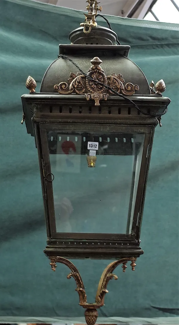 A pair of Victorian style gilt and patinated lanterns of square tapering form, each with gilt metal embellishments, suspended by linked chains, lanter