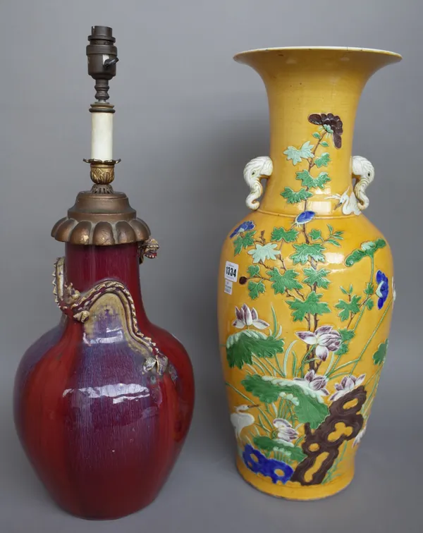 A Chinese yellow ground vase, early 20th century, with elephant head handles and relief foliate decoration, 58cm high, and a Chinese sang de bouef vas