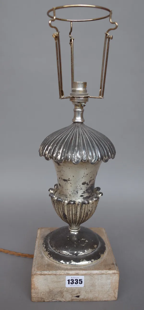 A silvered metal table lamp of urn form on a wooden plinth and an ebonised clock wall bracket with ormolu embellishments, 50cm wide and a marble circu