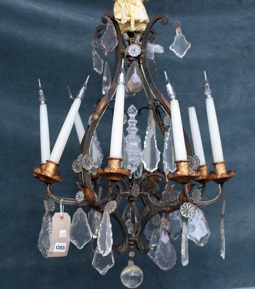 A wrought iron, gilt metal and glass mounted eight branch chandelier of open frame form hung with shaped glass drops, 65cm high.