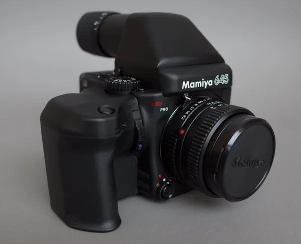 A Mamiya 645 pro camera, a 150mm lens & film, all boxed.