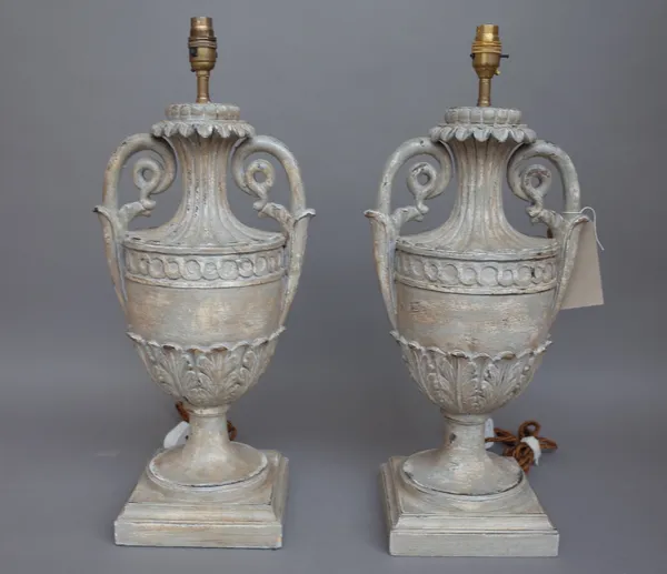 A pair of modern Italian style carved wooden table lamps, each of twin handled urn form, distressed grey on a stepped square base, 50cm high, (2).