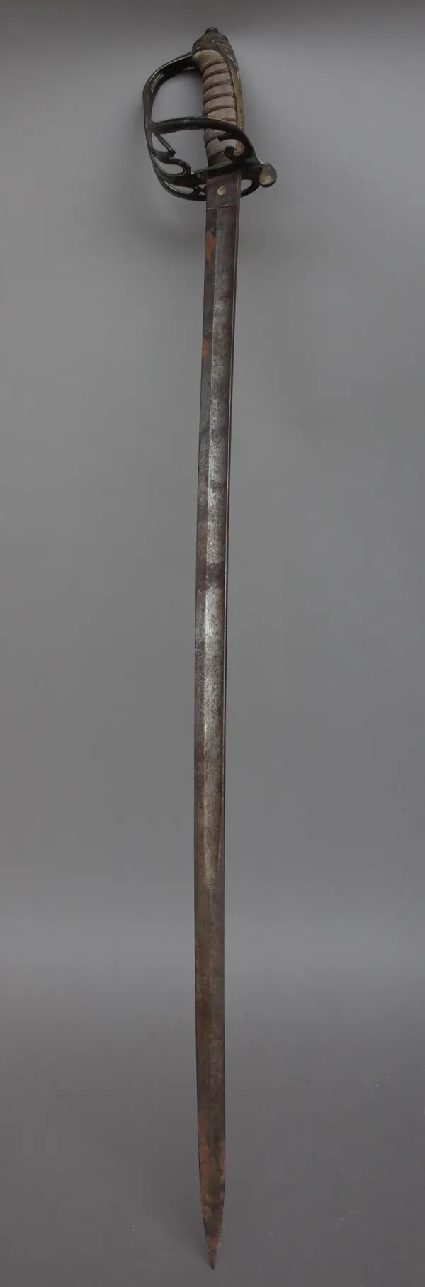 An English officer's sword, 19th century, with slightly curved engraved steel blade, 83cm, and wire bound fish skin grip, (a.f.).