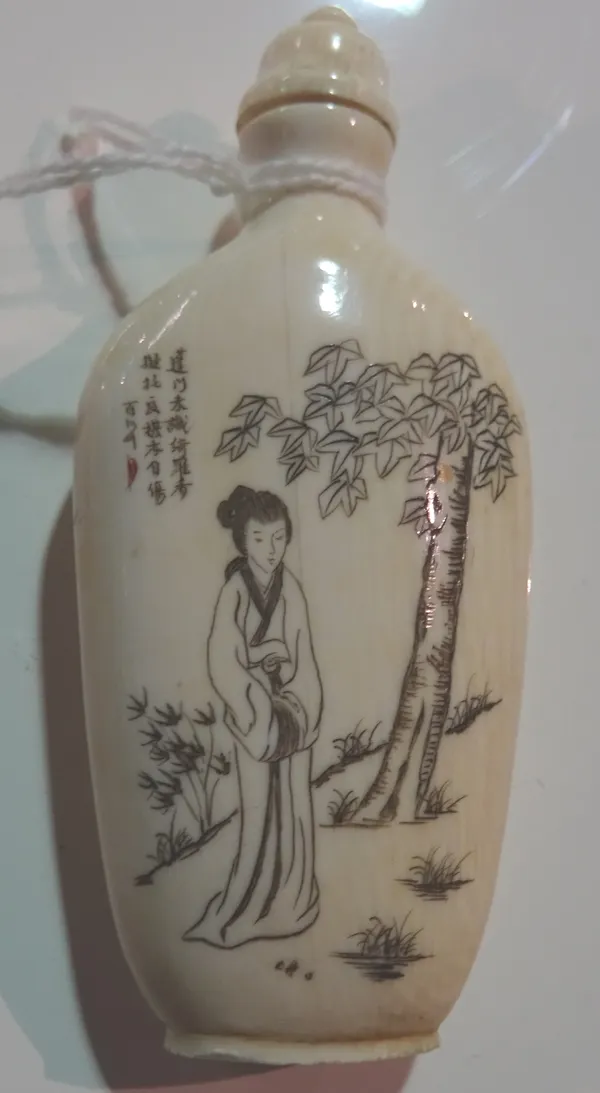 An ivory snuff bottle, early 20th century, one side decorated with a young woman standing before a tree below lines of script, the reverse with rows o
